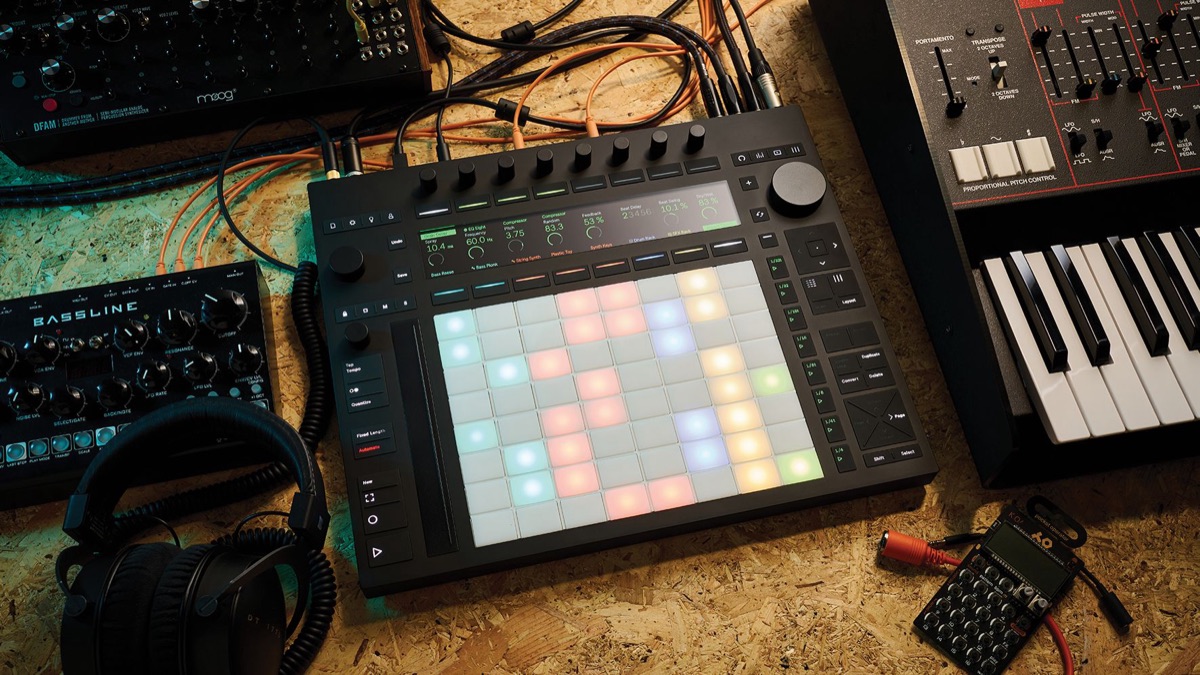 64-pad controller surrounded by studio gear